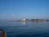 The lighthouse at the edge of the harbor was bathed in the morning light.