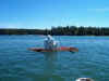 The weird man-thing on the raft behind the boat